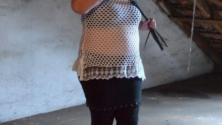 Woman named Rubens in a mini skirt and whip